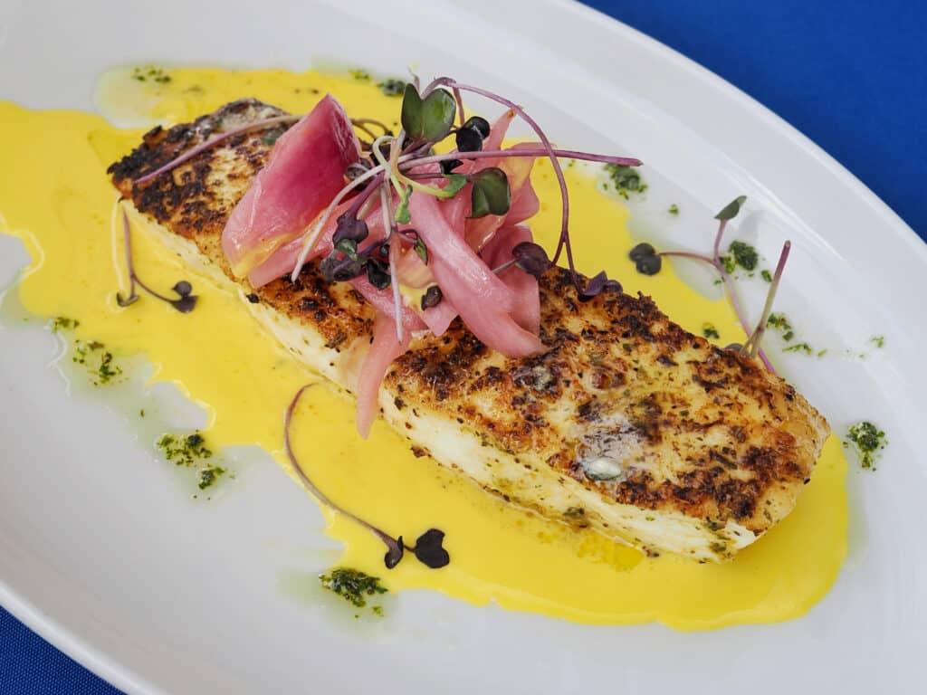 Wild-caught halibut entrée plated at The Nauti Lobstah, one of the best fish dishes in Orlando