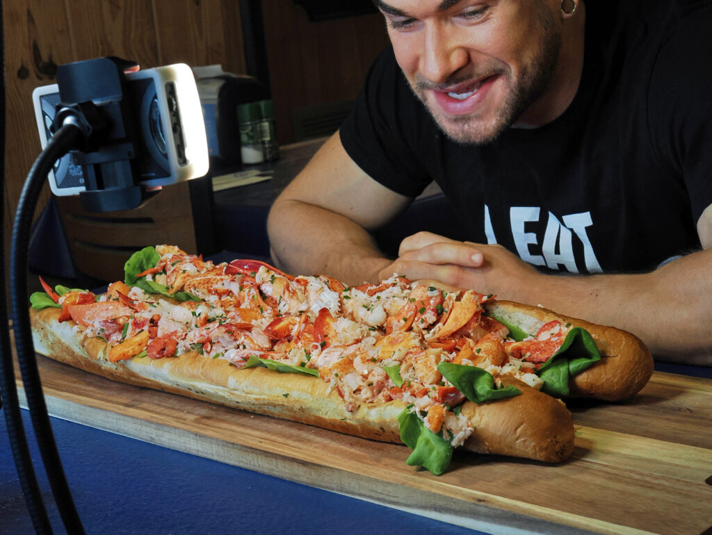 YouTuber Joel Hansen of ModelVsFood enjoying The Biggest Lobster Roll in Florida