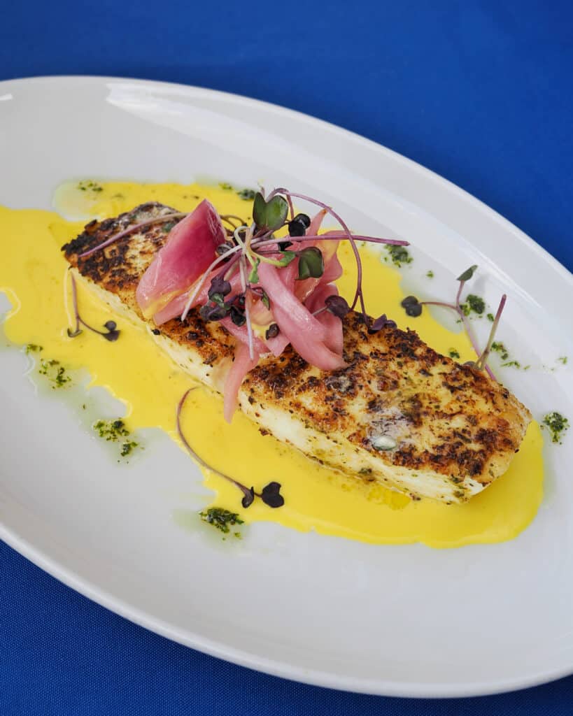Pan-seared halibut fillet with saffron beurre blanc at The Nauti Lobstah for the best fish in Orlando