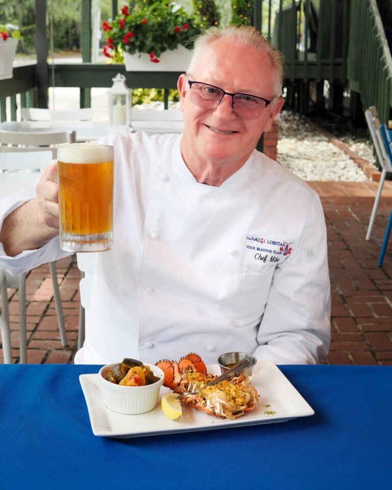 Chef Mike Rumplik of The Nauti Lobstah raises a glass of his favorite craft beer to the best seafood restaurant in Orlando