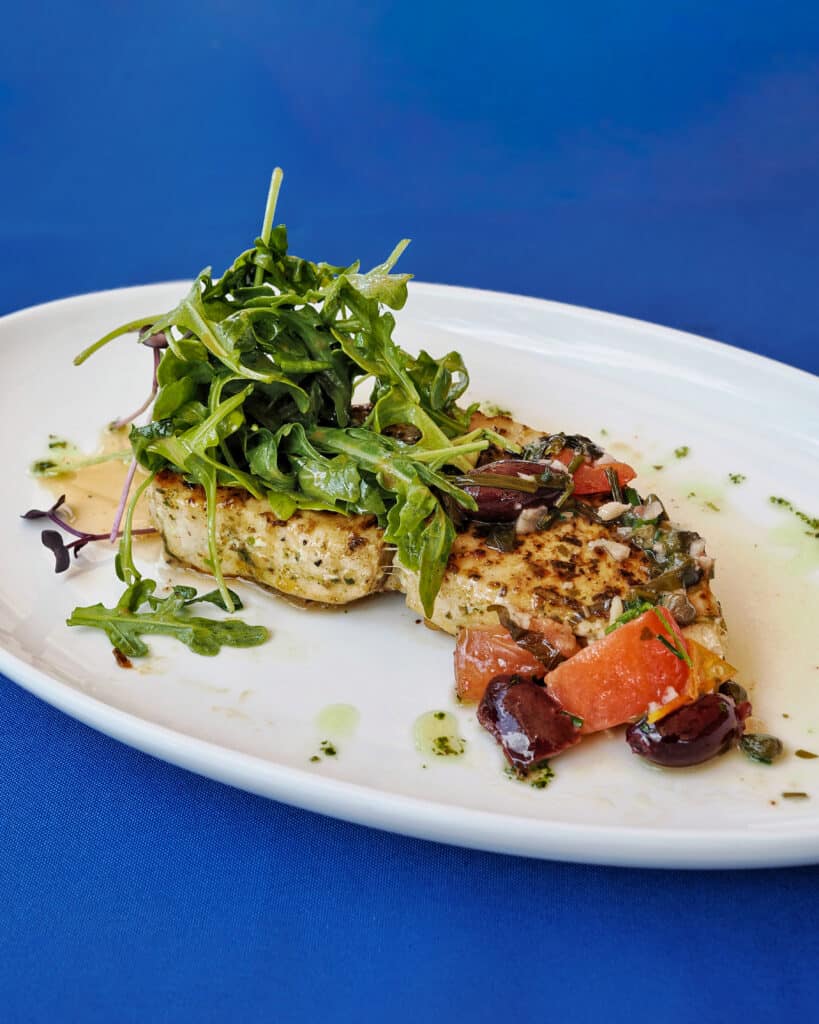 Grilled swordfish steak with Mediterranean toppings at The Nauti Lobstah in Apopka near Orlando